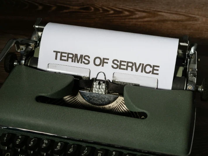 Typewriter with a sheet of paper reading "Terms of Service."