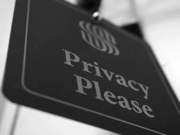 Sign reading "Privacy Please" in simple black and white design.